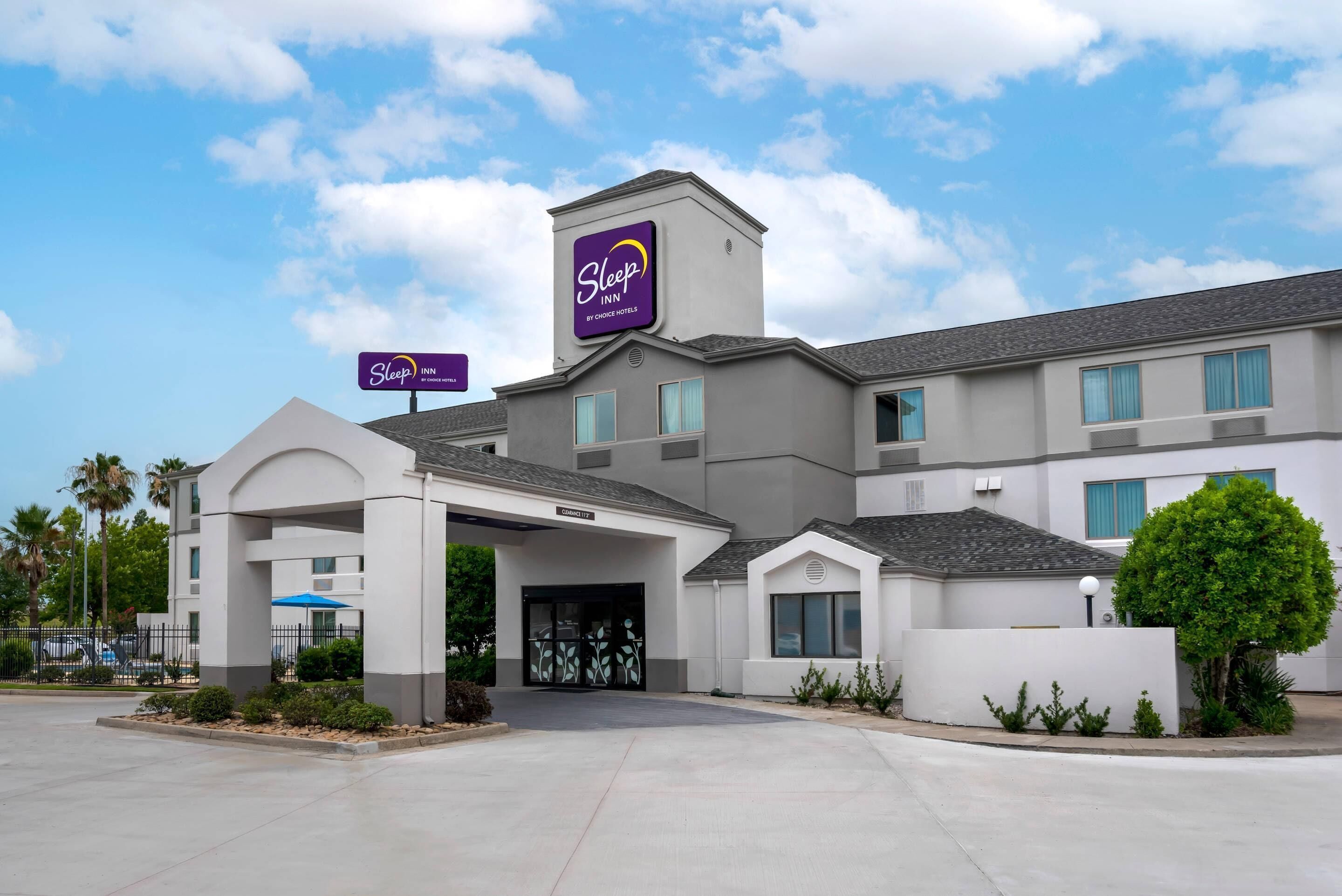 A Sleep Inn by Choice Hotels building with a modern design, featuring a prominent entrance and signage.