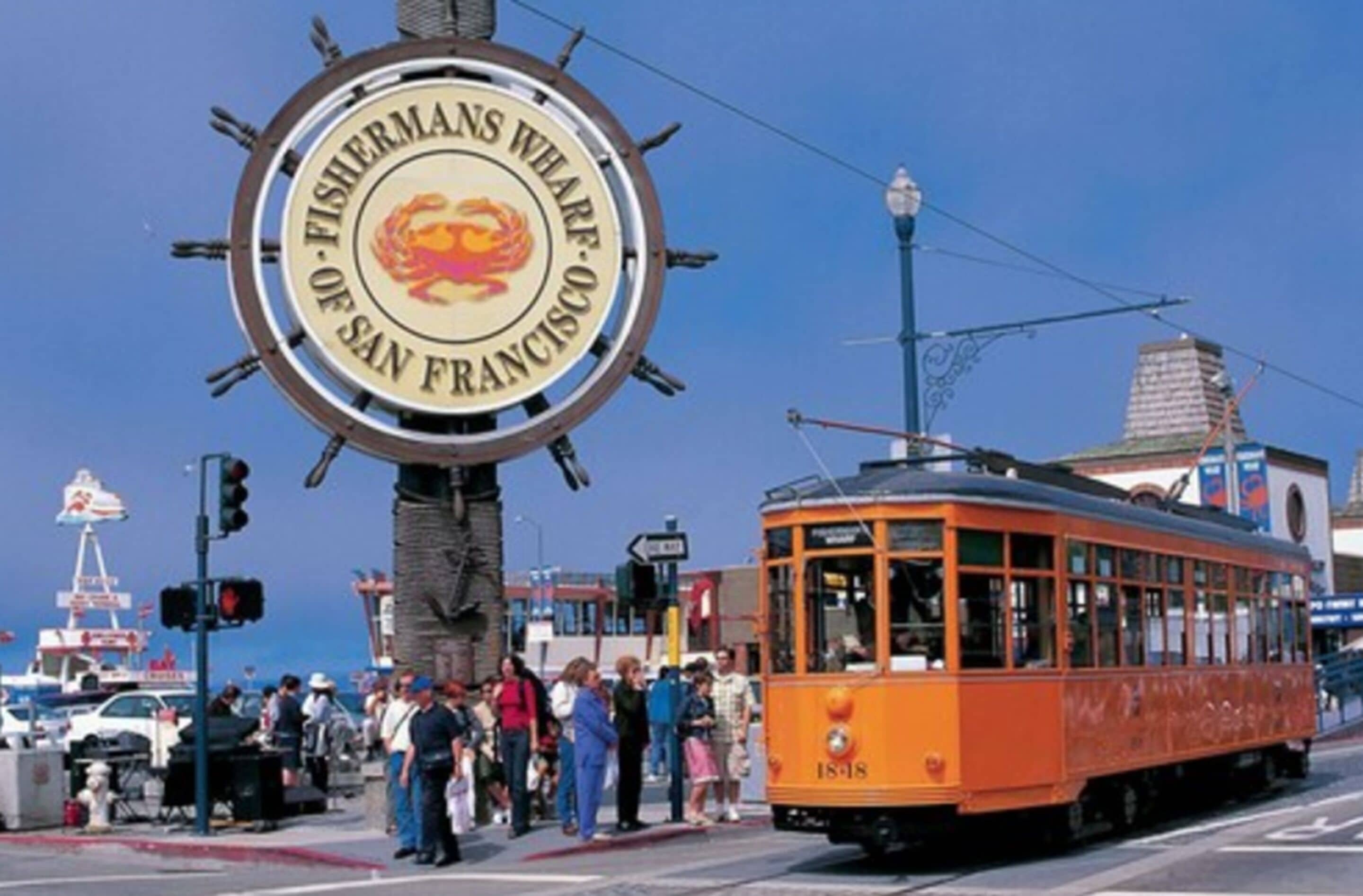 A circular sign with the text "FISHERMANS WELARF OF SAN FRANCISCO" and a red fish emblem.