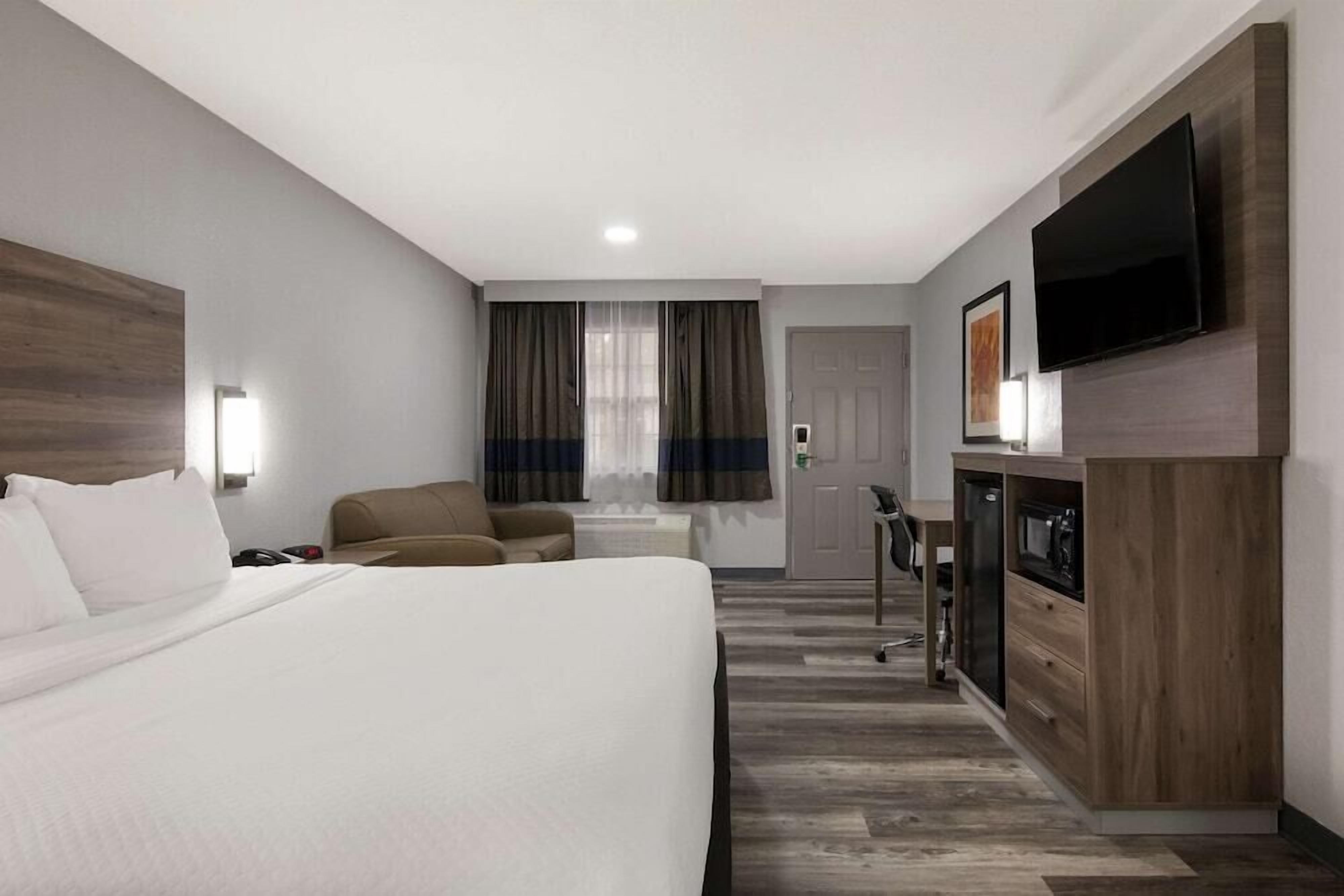 Premium bedding, desk, laptop workspace, blackout drapes