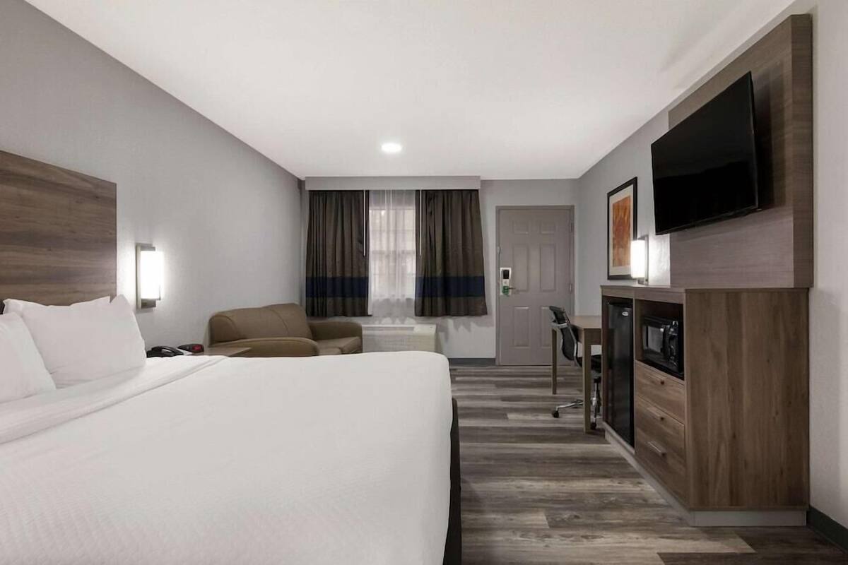 Premium bedding, desk, laptop workspace, blackout drapes