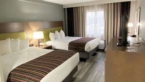 A hotel room with two beds, a desk, a lamp, and a TV. - Best Western Kennesaw (Kennesaw)