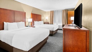 A hotel room with two beds, a desk, a TV, and a large window with curtains. - Comfort Inn University Area (Baton Rouge)