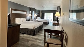 A hotel room with two beds, a desk, and a chair. - Best Western Americana (Dinuba)