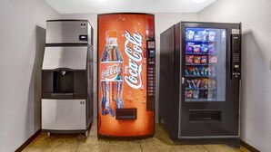 A vending machine with a Coca-Cola logo, a water dispenser, and a snack vending machine. - Motel 6 Silver City, NM (Silver City)