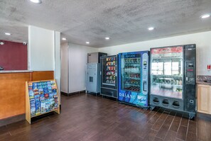 A lobby with vending machines, a reception desk, and a display of travel brochures. - Red Roof Inn Palmdale - Lancaster (Palmdale)