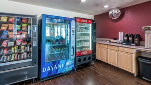 A vending area with snack and drink machines, including Dasani water and Coca-Cola. - Red Roof Inn Palmdale - Lancaster (Palmdale)