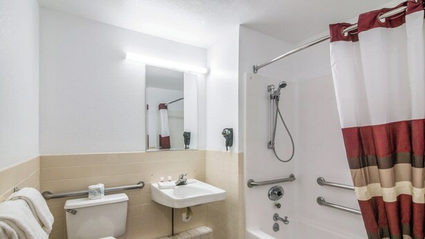 A standard hotel bathroom with a toilet, sink, and shower. - Red Roof Inn Palmdale - Lancaster (Palmdale)