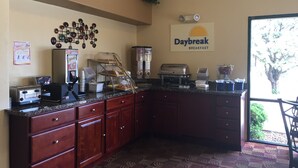 A breakfast area with a Daybreak sign, a coffee machine, a toaster, and a salad bar. - Days Inn by Wyndham Globe (Globe)