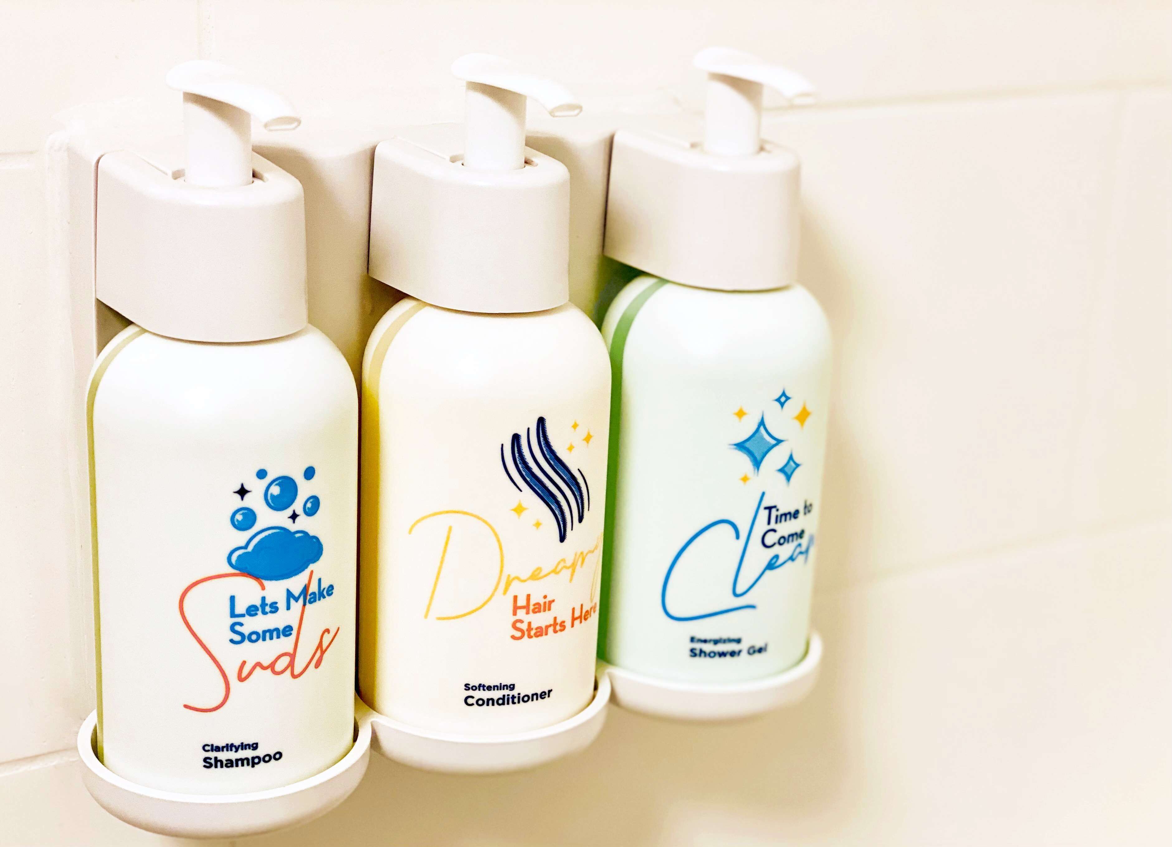 Three bottles of hair care products on a shelf.