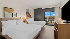 A hotel room with two beds, a desk, a TV, and a balcony with a view. - Spark by Hilton Fountain Hills Scottsdale (Fountain Hills)
