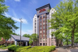 A hotel with a sign reading 'Hampton Inn & Suites,' a covered entrance, and a parking area. - Hampton Inn & Suites Atlanta/Duluth/Gwinnett County (Duluth)