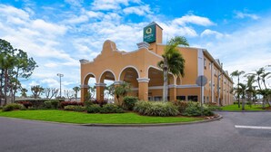A hotel with a distinctive architectural style, featuring arched windows and a prominent sign. - Quality Inn - Near Serenoa Golf Club (Sarasota)