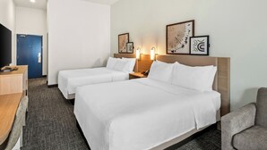 A hotel room with two beds, a desk, a chair, and artwork on the wall. - Spark by Hilton Duluth (Duluth)