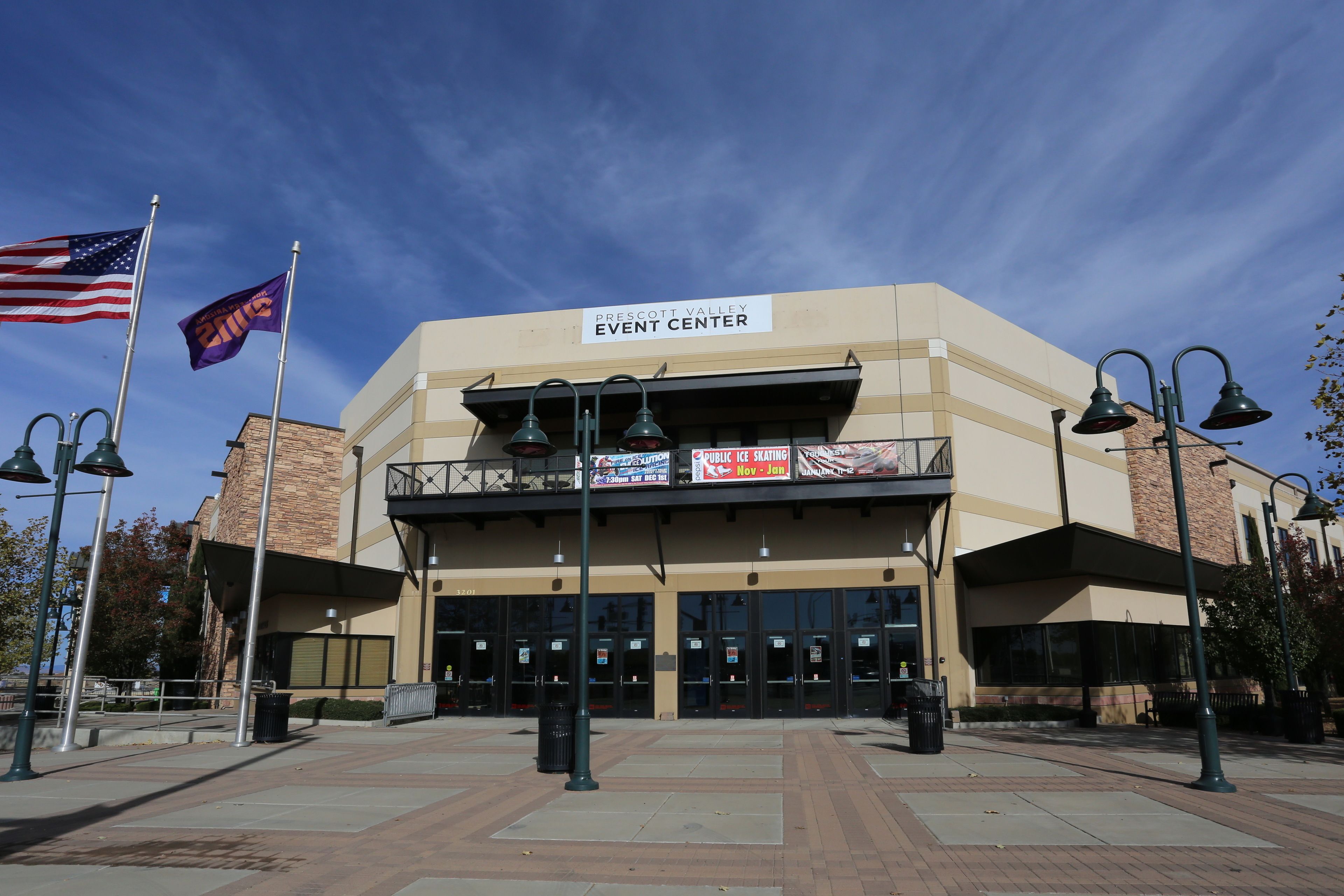 A building labeled "Prescott Valley Event Center" with a sign for "Public Ice Skating" and an American flag.