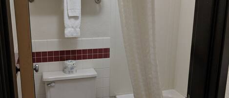 A bathroom with a toilet, sink, and bathtub.
