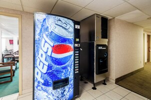 A vending machine with a Pepsi logo, an ice dispenser, and a card reader.