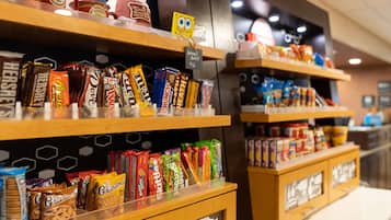Shelves stocked with various snacks and beverages, including Hershey's and Grandma's brands.