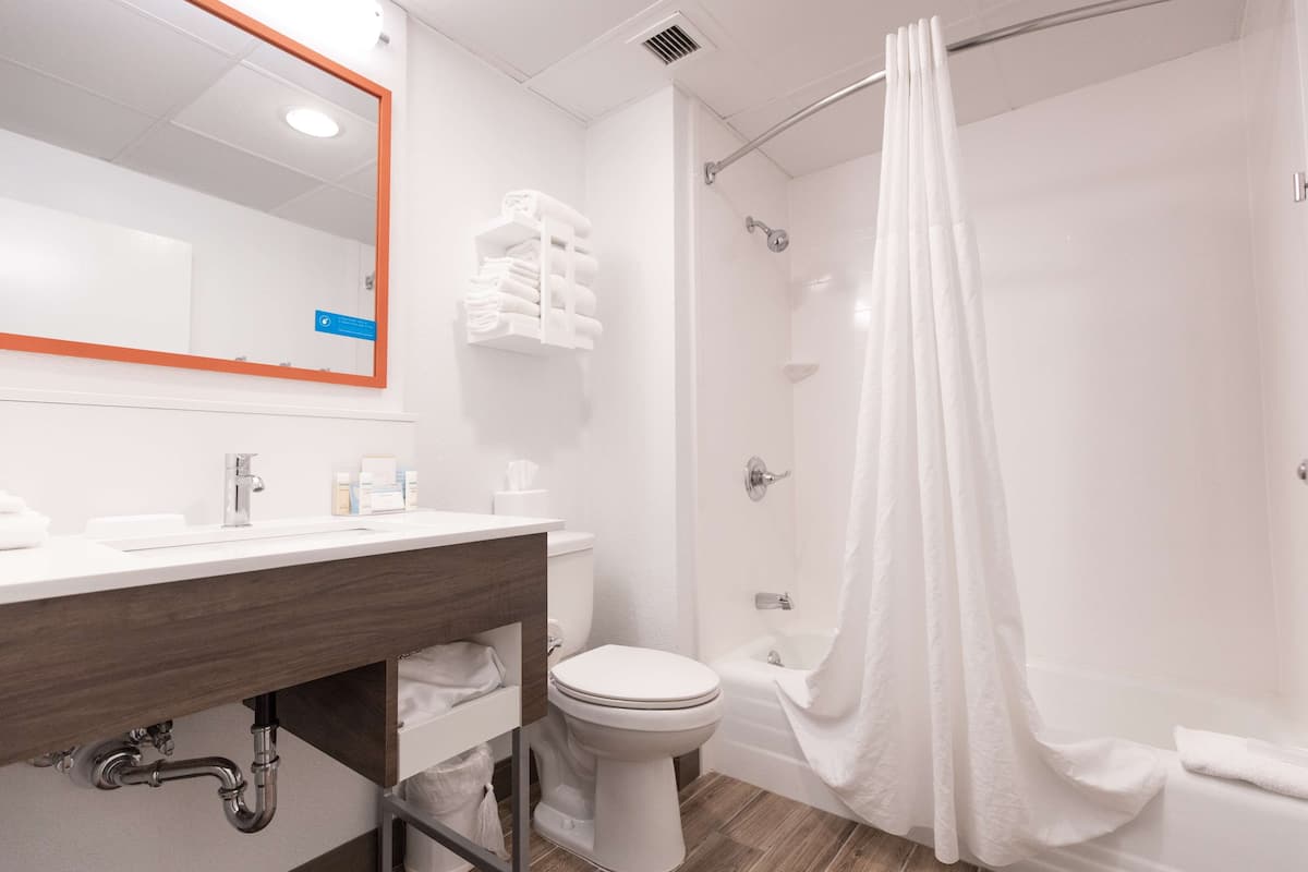 room, 2 queen beds, refrigerator & microwave | bathroom | free toiletries, hair dryer, towels