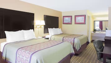 A hotel room with two beds, a desk, a chair, a lamp, and a mirror.
