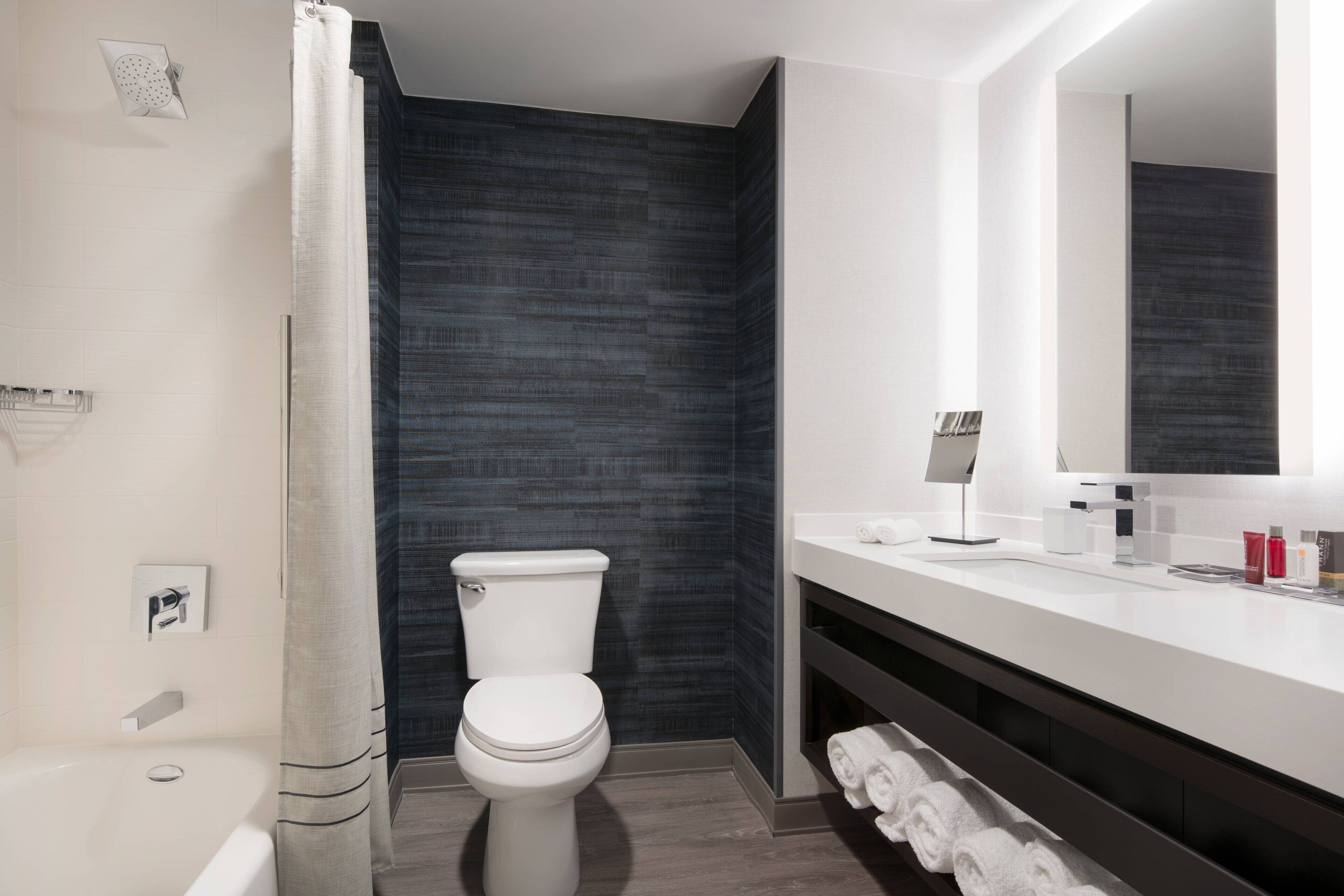 designer toiletries, hair dryer, towels, soap