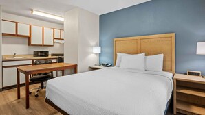 A hotel room with a bed, a desk, a microwave, a telephone, and a nightstand. - Extended Stay America Suites Fort Wayne North (Fort Wayne)
