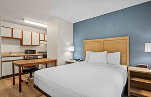 A hotel room with a bed, a desk, a microwave, a telephone, and a nightstand. - Extended Stay America Suites Fort Wayne North (Fort Wayne)