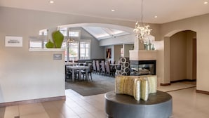 A modern hotel lobby with a central seating area, a dining area in the background, and a skylight. - Residence Inn by Marriott Cincinnati Airport Erlanger (Erlanger)
