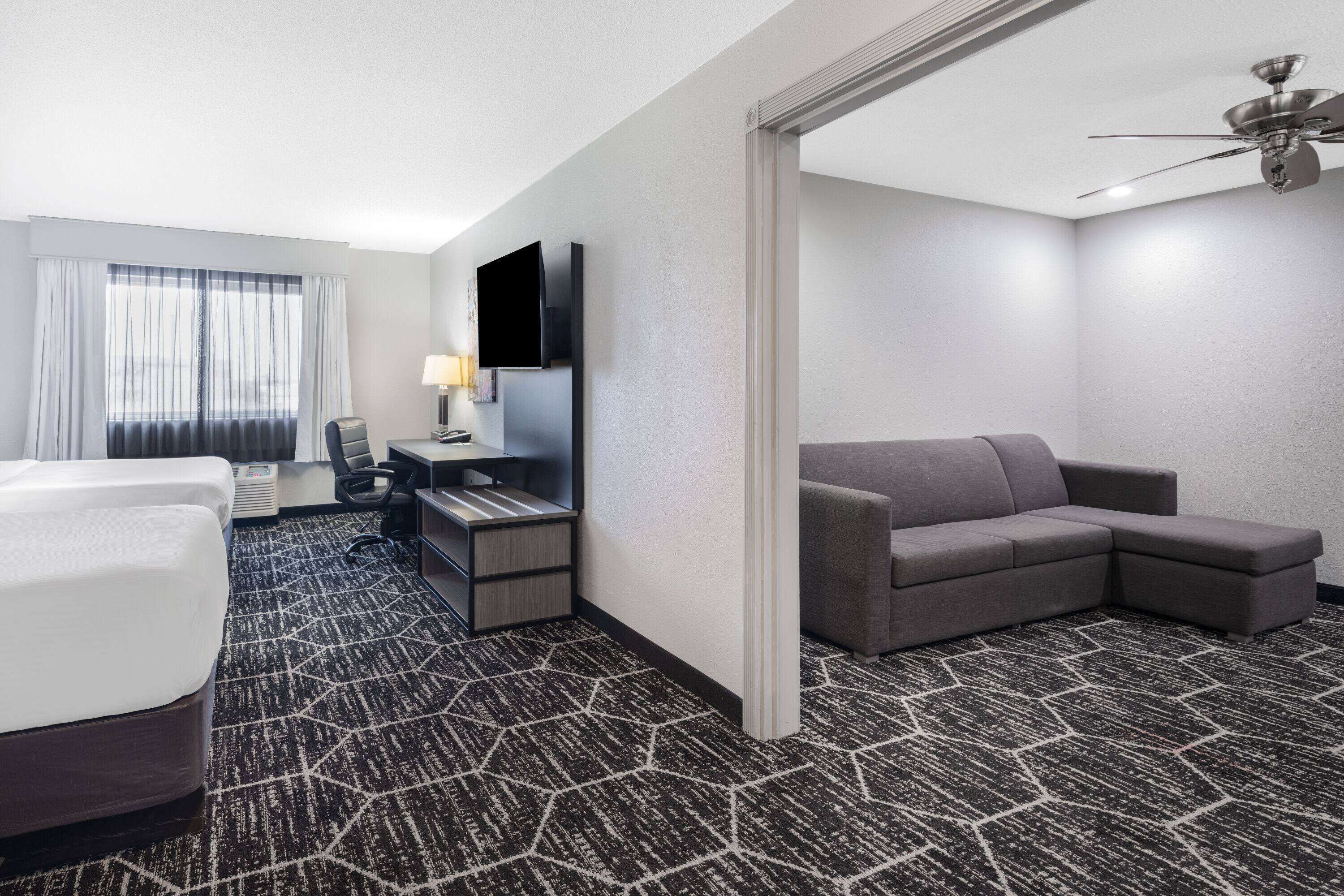 family room, 2 queen beds, non smoking (deluxe) | premium bedding, desk, iron/ironing board, free cots/infant beds