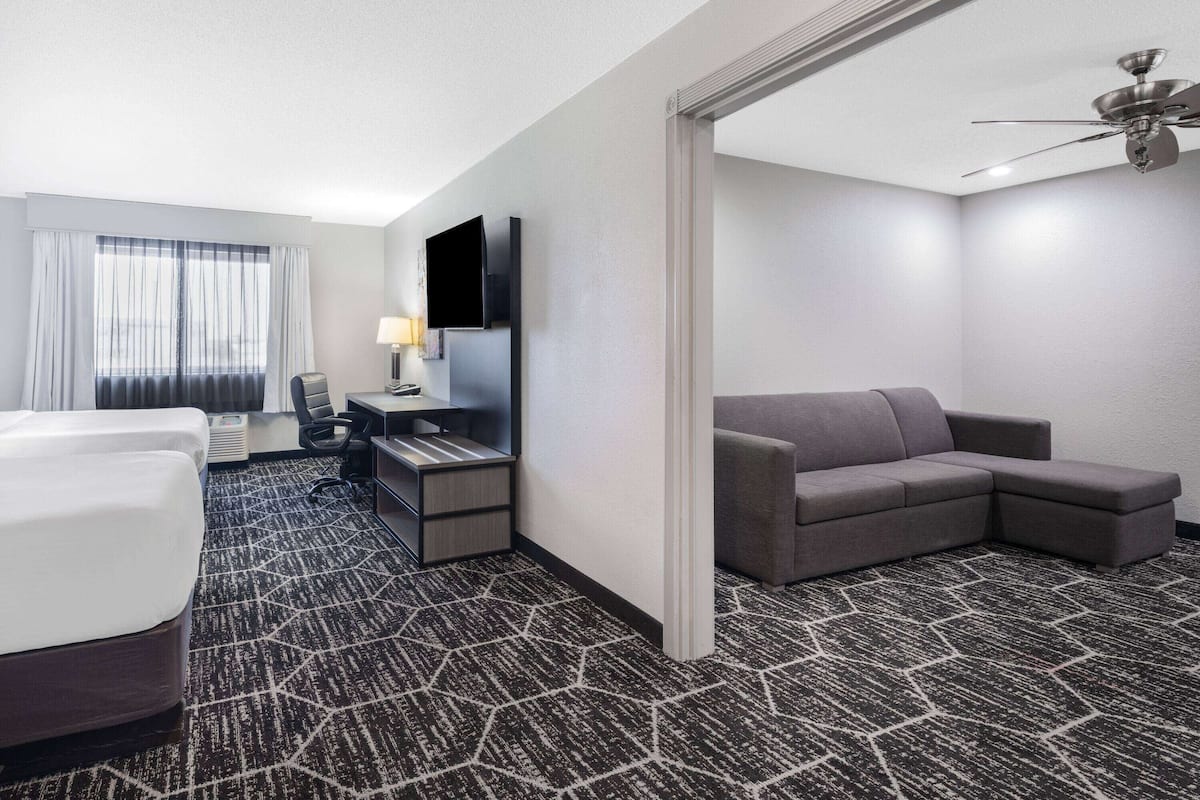 family room, 2 queen beds, non smoking (deluxe) | premium bedding, desk, iron/ironing board, free cots/infant beds