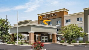 Un hotel La Quinta con una fachada moderna, un logotipo destacado y una zona de acceso cubierta.