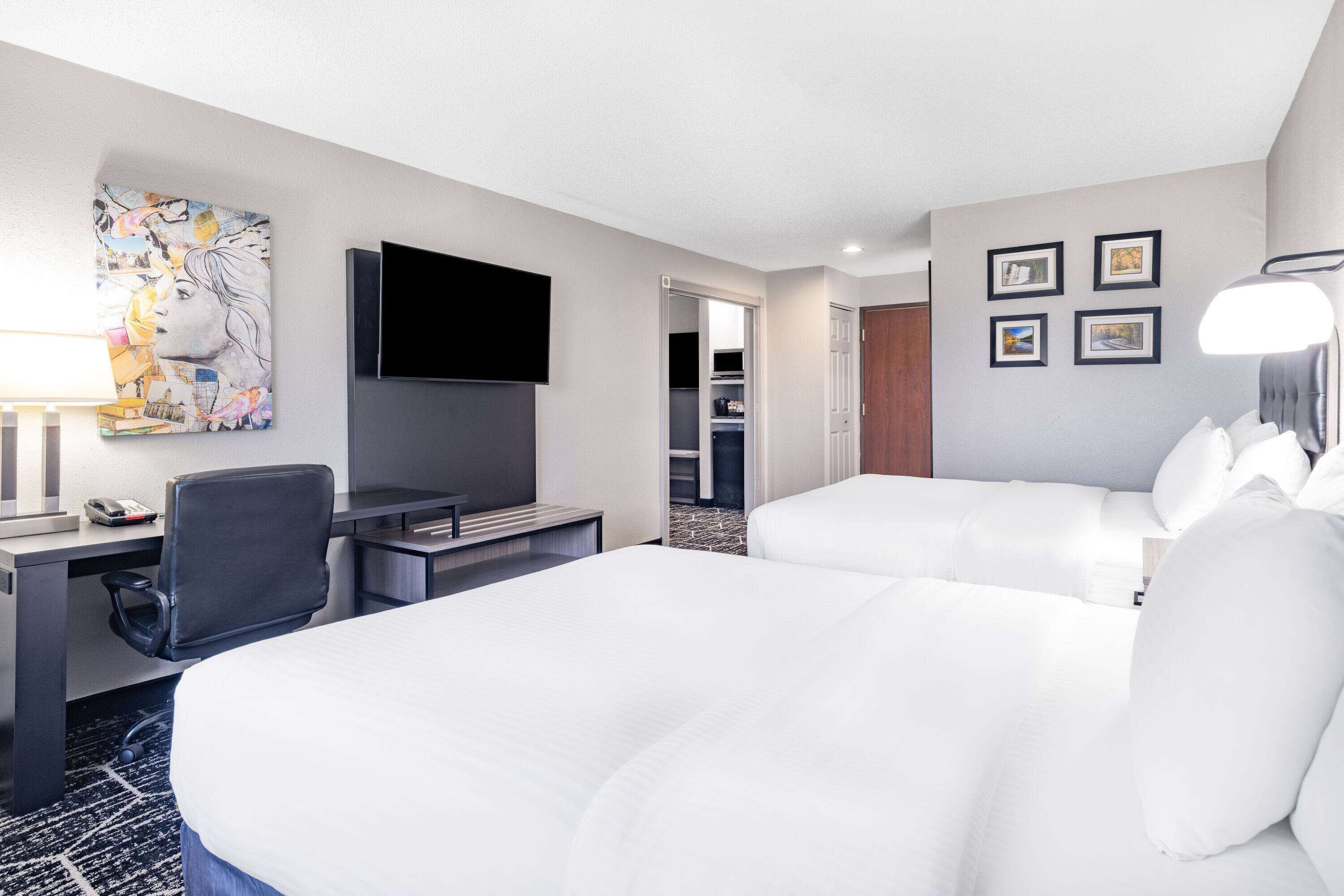 family room, 2 queen beds, non smoking (deluxe) | premium bedding, desk, iron/ironing board, free cots/infant beds