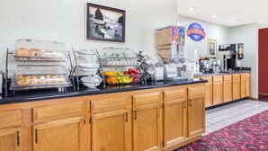 Una barra de desayuno con diferentes alimentos y una máquina de café.