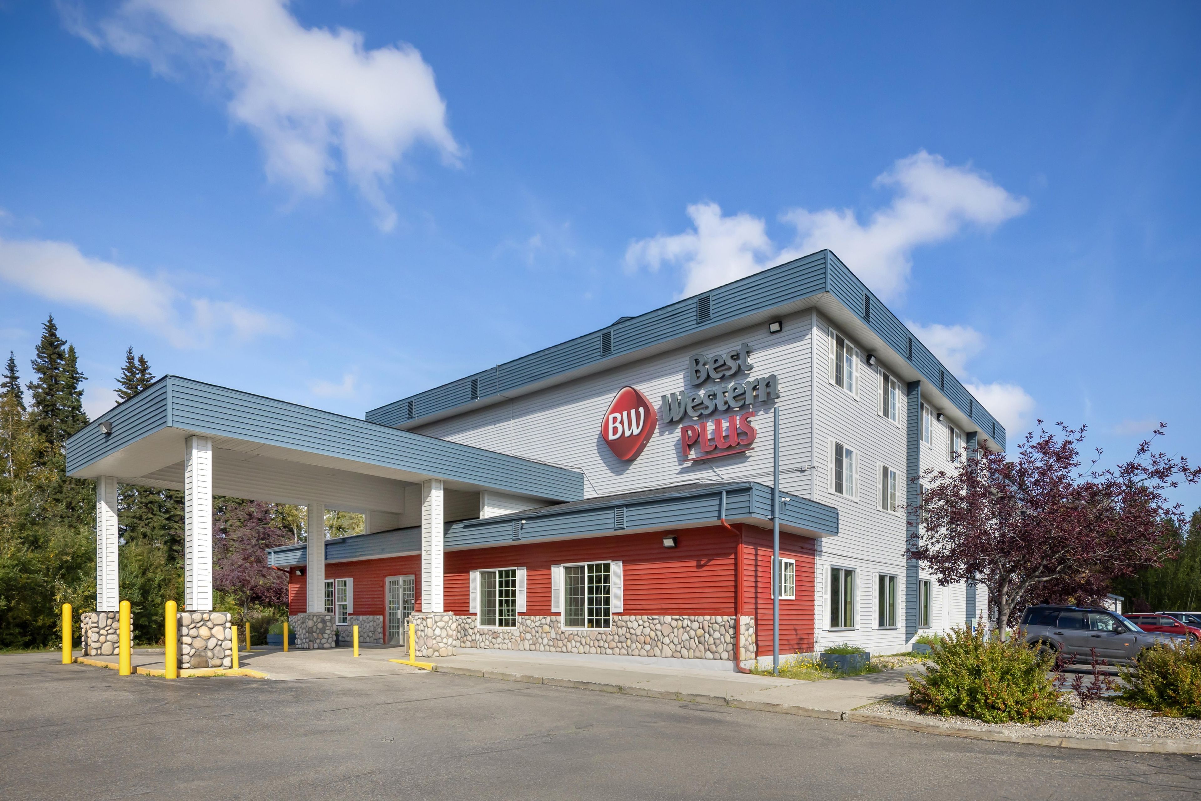 A Best Western Plus hotel with a covered parking area and a stone facade.