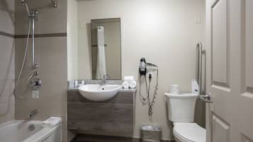 A modern bathroom with a bathtub, a sink, a toilet, and a shower.