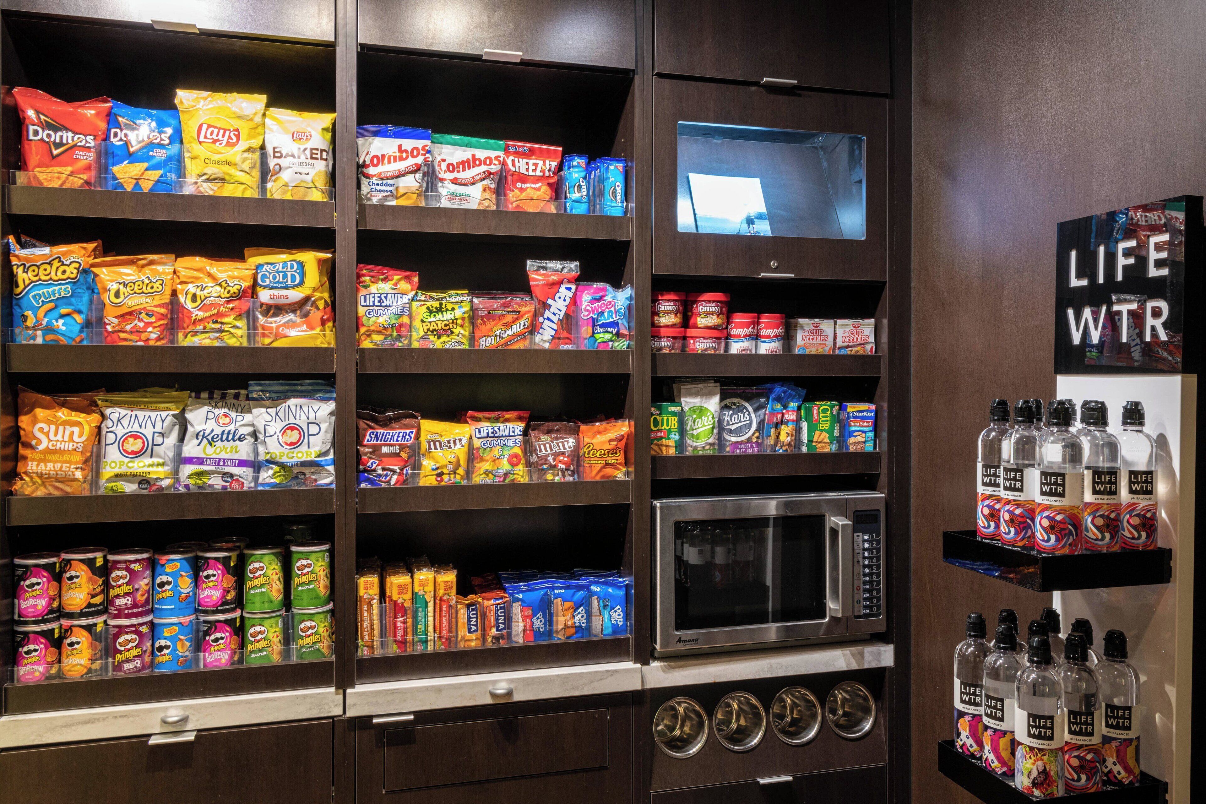A snack and beverage display with various brands and types of snacks and drinks.