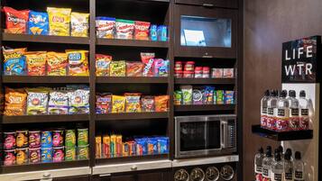 A snack and beverage display with various brands and types of snacks and drinks.