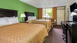 A hotel room with two beds, a desk, a chair, and a television. - Days Inn by Wyndham York Alabama (York)