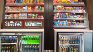 A snack and beverage vending machine with various brands of chips and drinks. - Hampton Inn Wichita-East (Wichita)