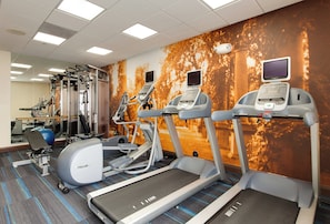 A fitness center with treadmills, a stationary bike, and weight machines. - Hotel Indigo Chicago-Vernon Hills by IHG (Vernon Hills)