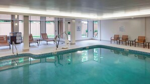 An indoor swimming pool with lounge chairs and a pool lift. - Courtyard Tuscaloosa by Marriott (Tuscaloosa)