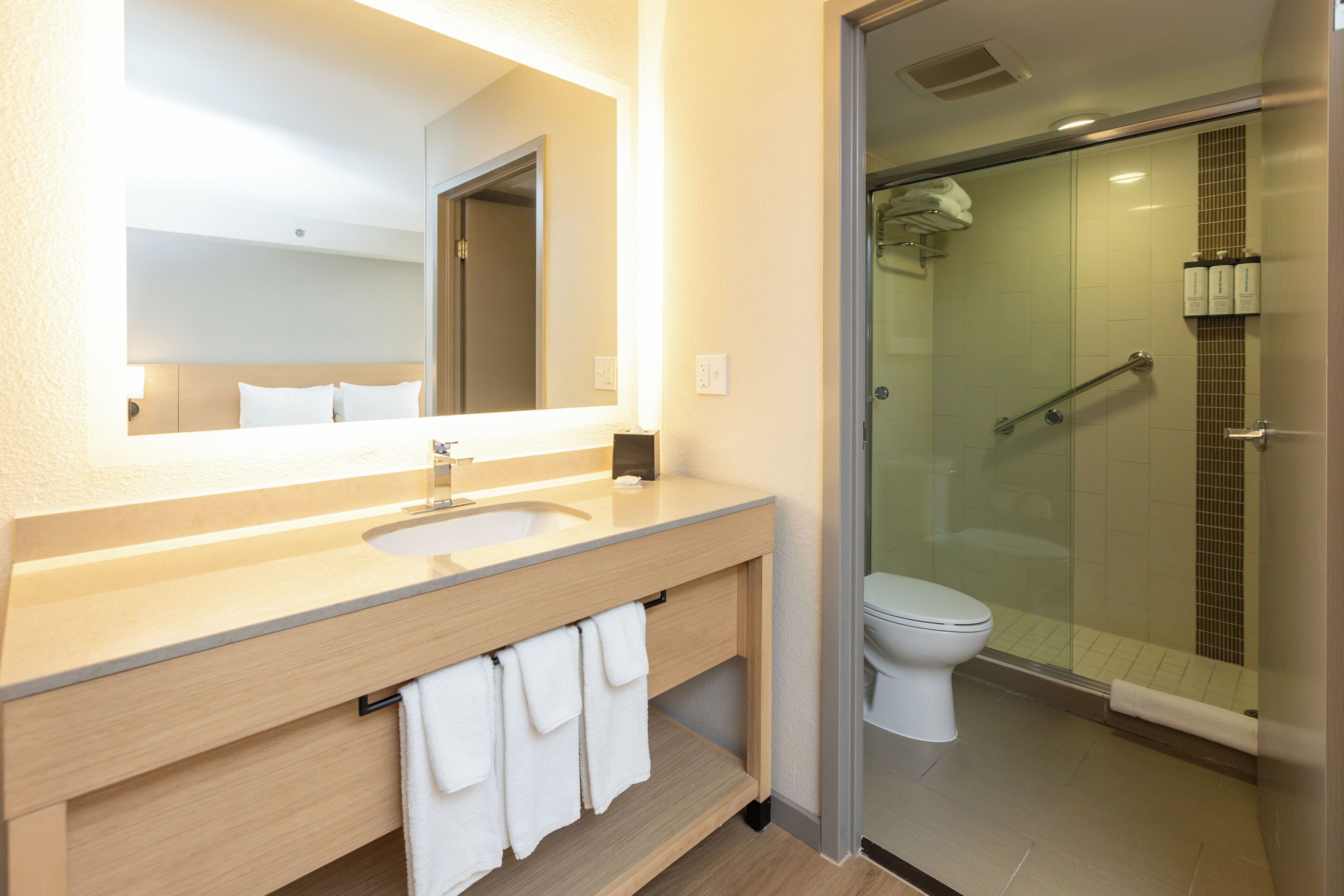 combined shower/bathtub, designer toiletries, hair dryer, towels