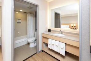 A modern bathroom with a bathtub, toilet, and sink. - Hyatt Place Topeka (Topeka)