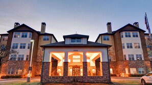 A multi-story building with a central entrance, large windows, and a brick facade. - Homewood Suites Kansas City/Overland Park (Overland Park)