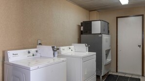 A laundry area with two Whirlpool washers and a stacked refrigerator. - Red Roof Inn & Suites Oxford (Oxford)