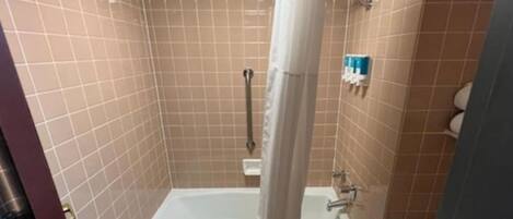 A bathroom with a bathtub, a shower, and a toilet.