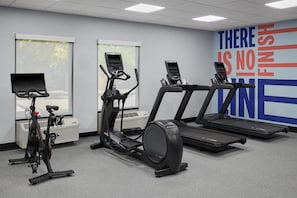 A gym with stationary bikes, elliptical machines, and treadmills. - Hampton Inn Lawrence (Lawrence)