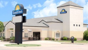 Ein Days Inn Hotel mit auffälliger Beschilderung, einem Haupteingang und einem Parkplatz.