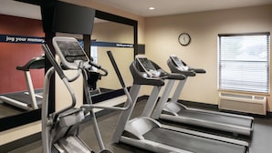 A gym with treadmills, a wall clock, and motivational posters. - Hampton Inn Chicago / Tinley Park (Tinley Park)