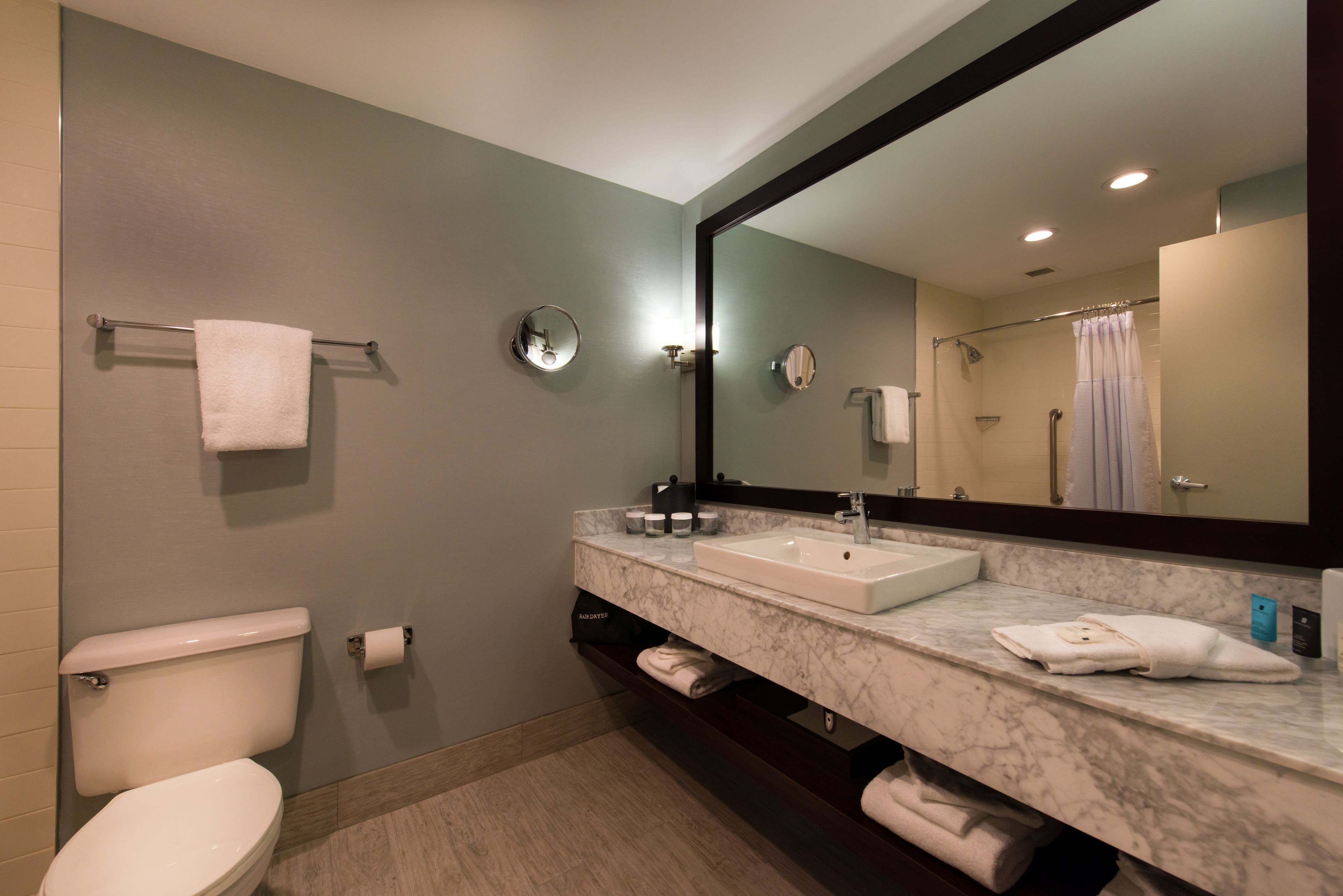 combined shower/bathtub, designer toiletries, hair dryer, towels