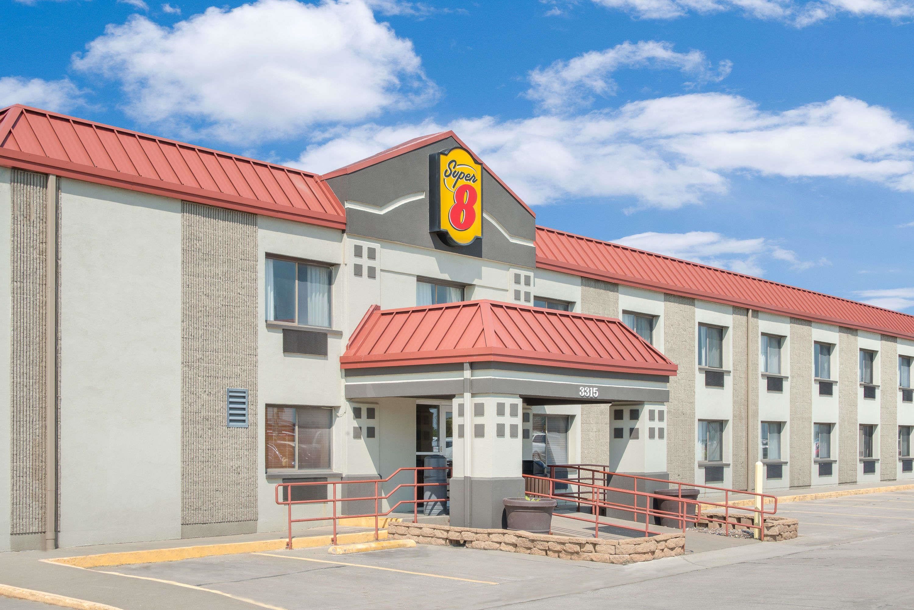 A Super 8 hotel with a red roof, a prominent 'Super 8' sign, and a number '3315' on the building facade.